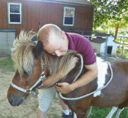 Man Hugging The Horse